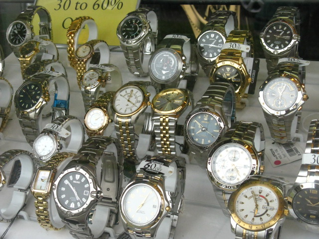 a bunch of watches on a table at a store