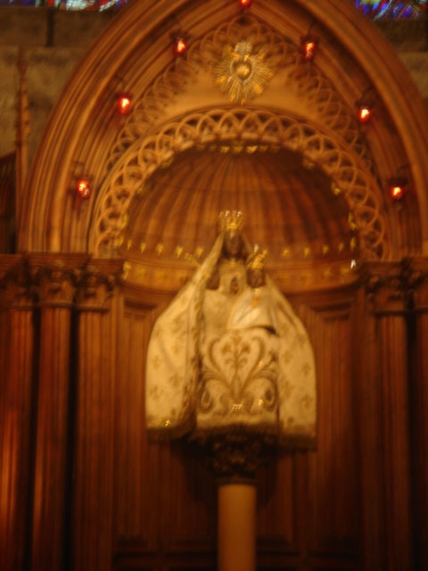 the alter of a church with ornate carvingwork and stained glass