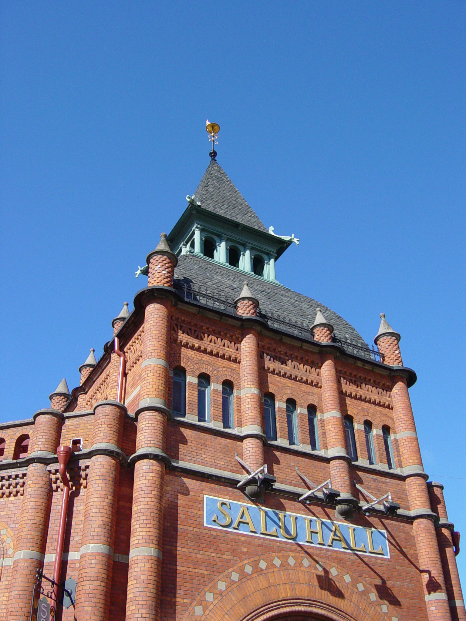 the tower of an old building has a clock displayed on it