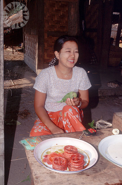 a woman sits next to some food outside