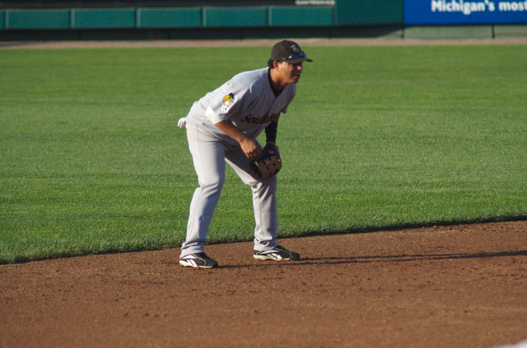 a baseball player is on the field waiting for his turn