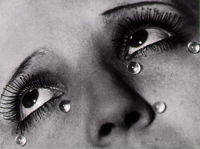a woman's face with water drops all over her eyes