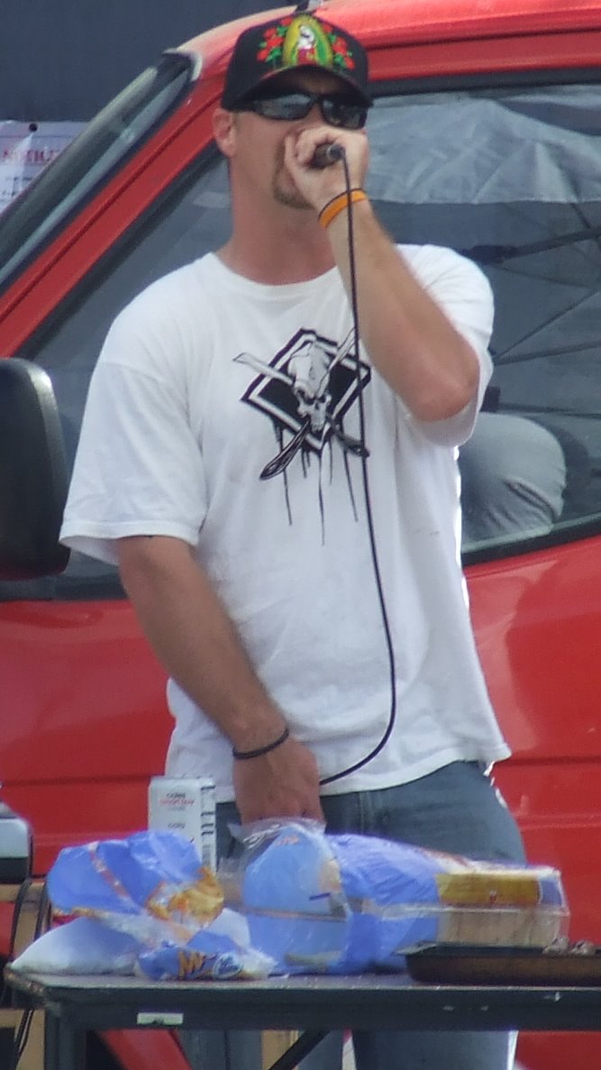 a man standing next to a red truck talking on a phone