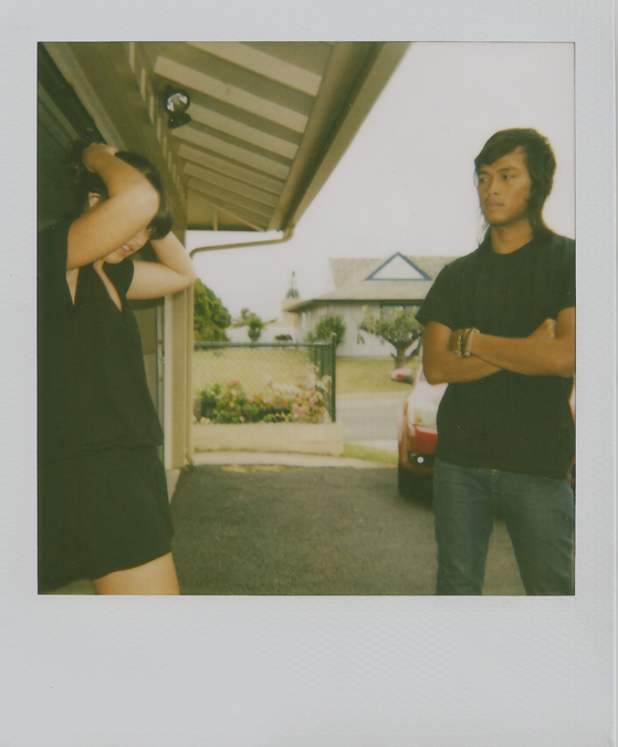 two people talking on the phone and under an awning