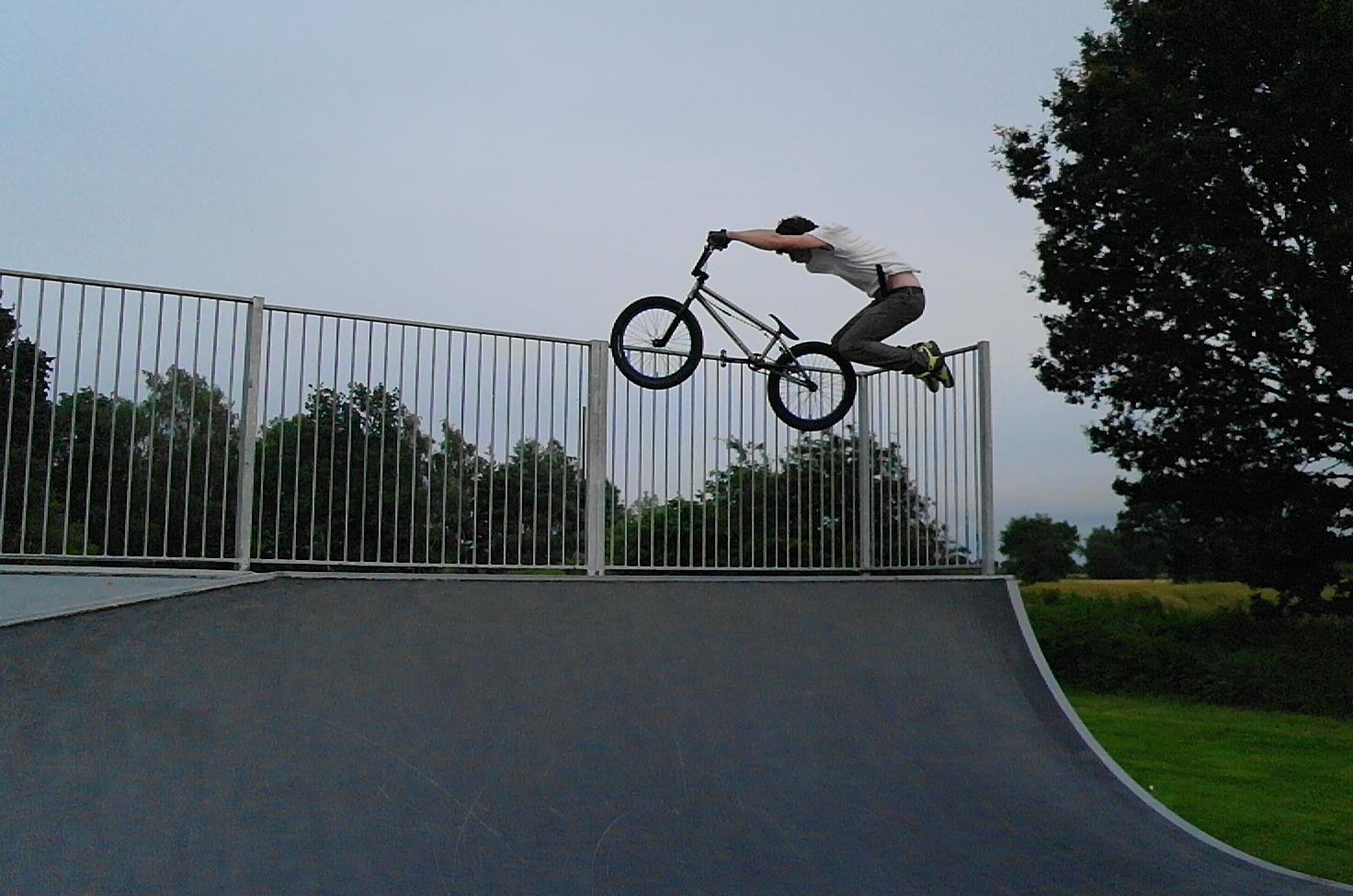 a person jumping a bicycle over a ramp