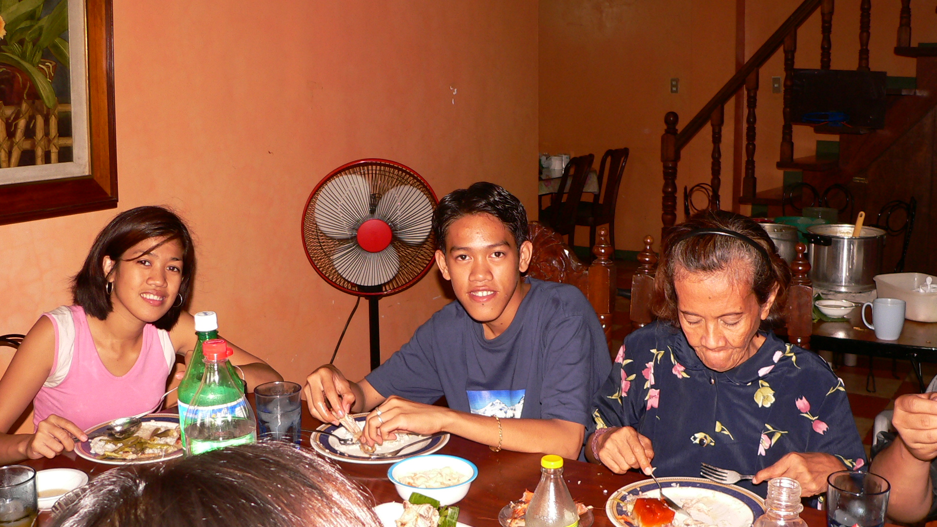 three men and two women sitting around a table together