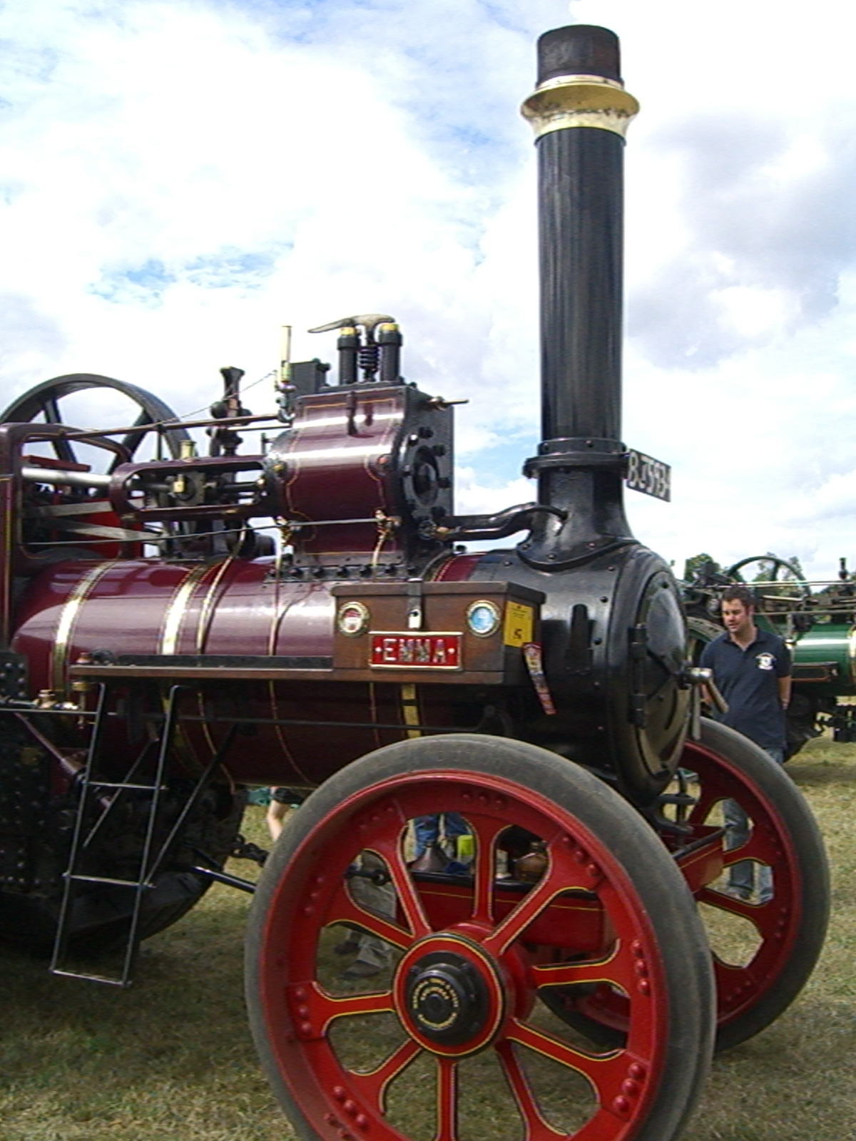 a red steam engine on display at a show