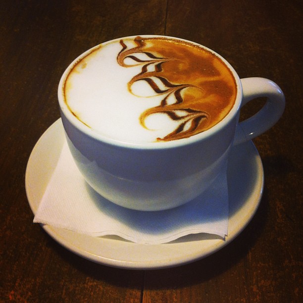 a latte art on top of a saucer in a cafe