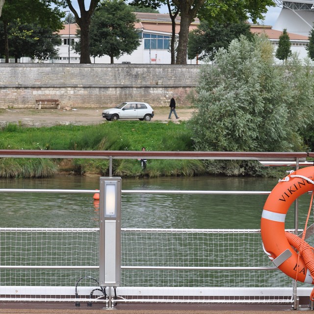 a life preserver is overlooking the water in front of a city street