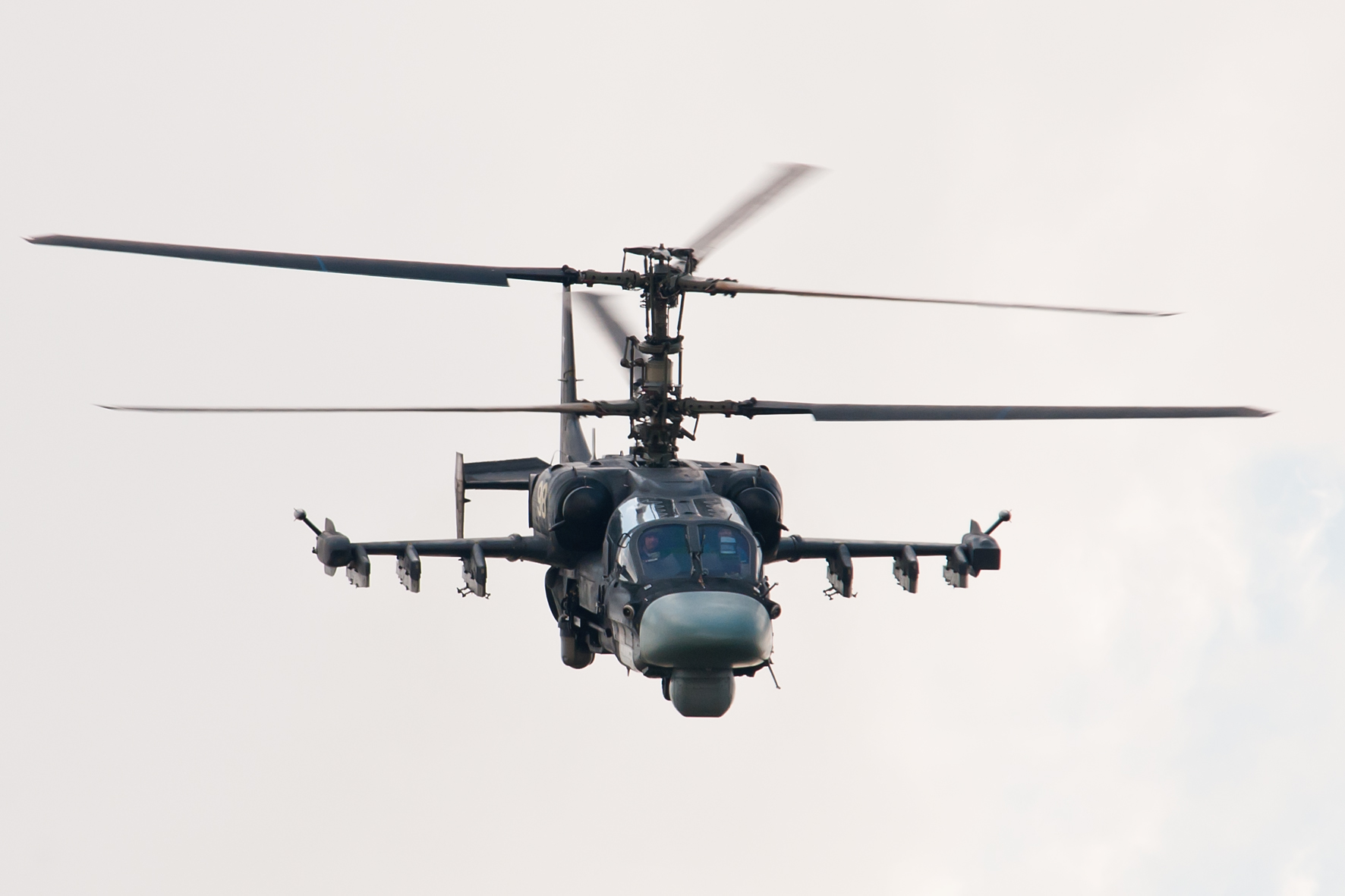 a helicopter flying in the sky with four engines