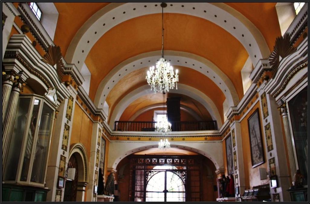 a chandelier hangs from the ceiling in a hall