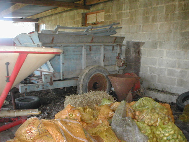 a machine is working in an outdoor barn