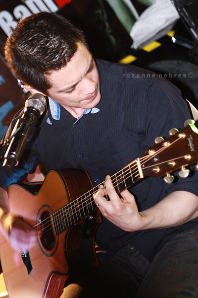 a man playing guitar at an event