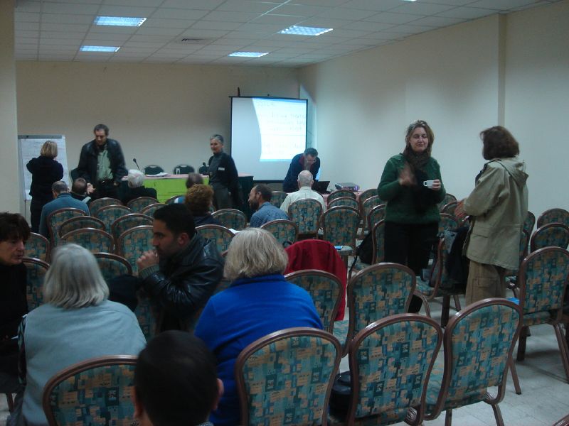 a large group of people are sitting and standing