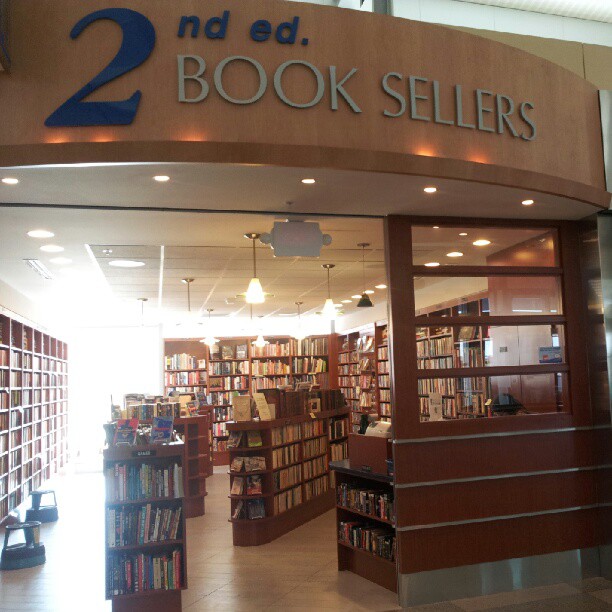 a bookstore with a two sided sign above the door