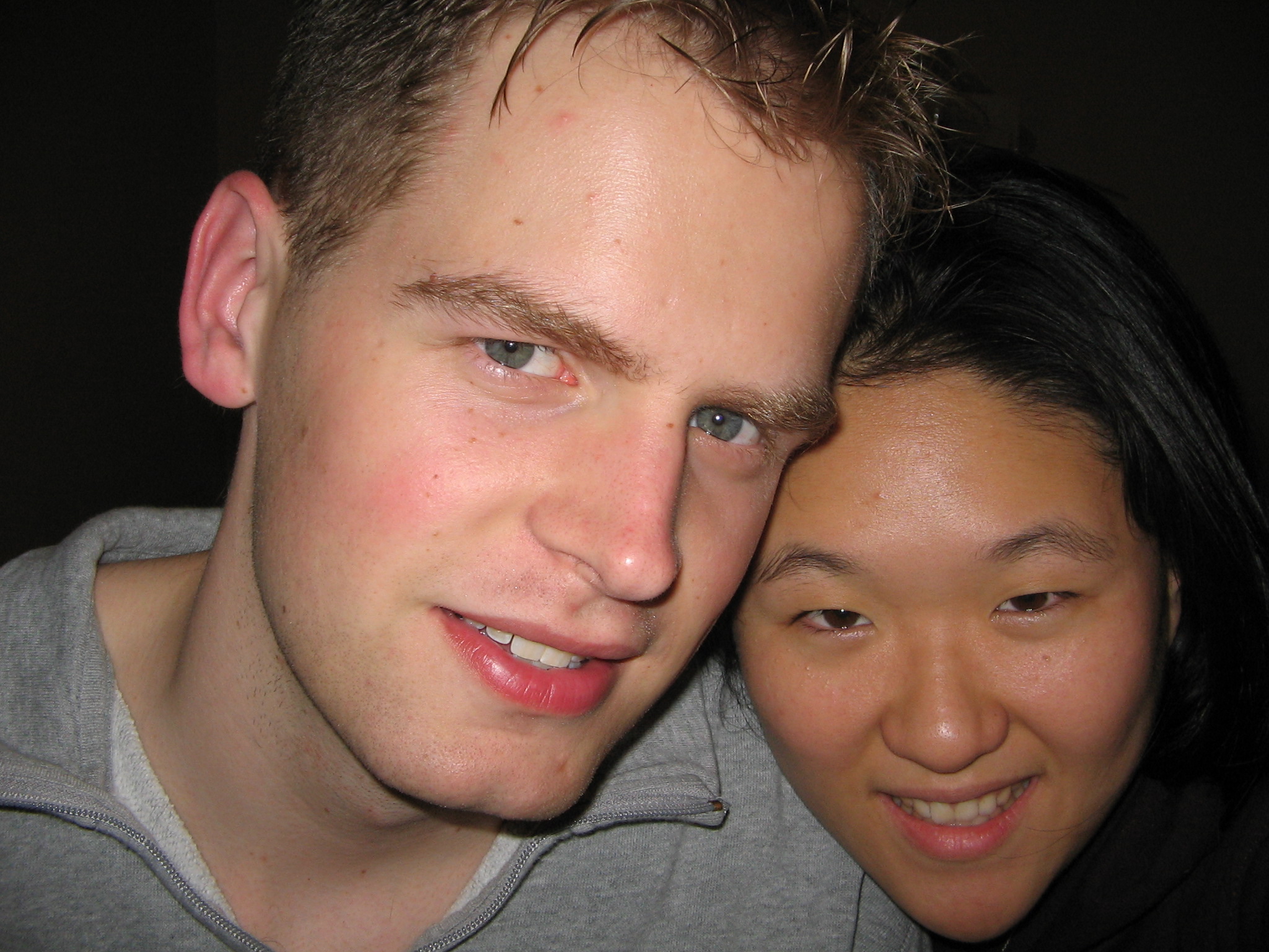 a smiling young man and woman taking a selfie