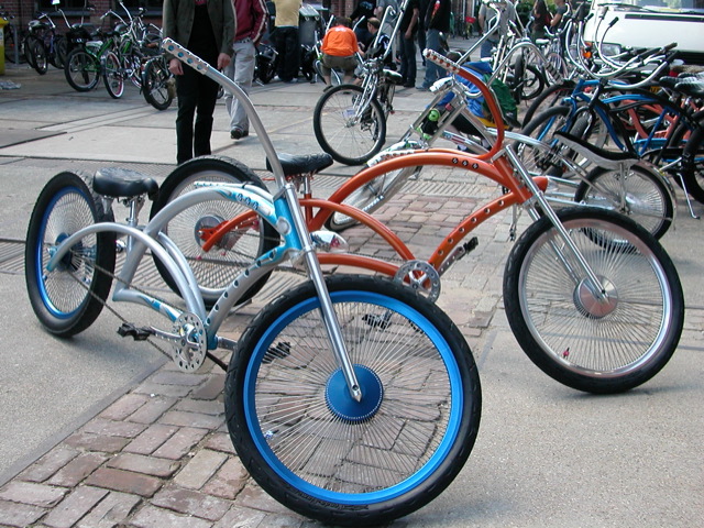 a couple of very pretty bikes on a sidewalk