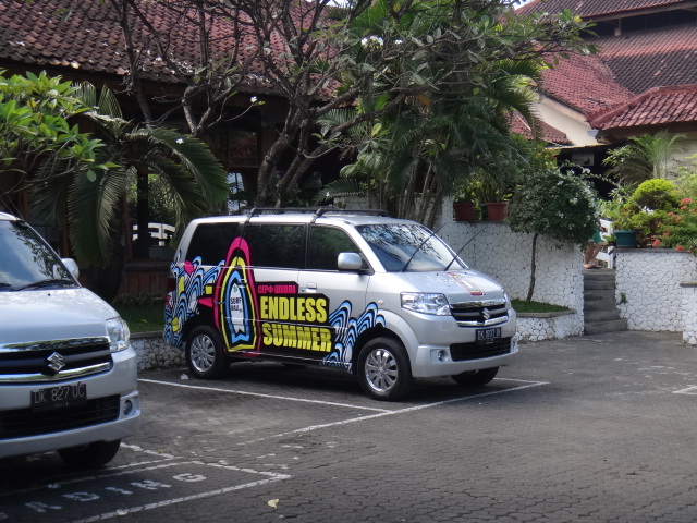 a car parked in a parking lot near a building