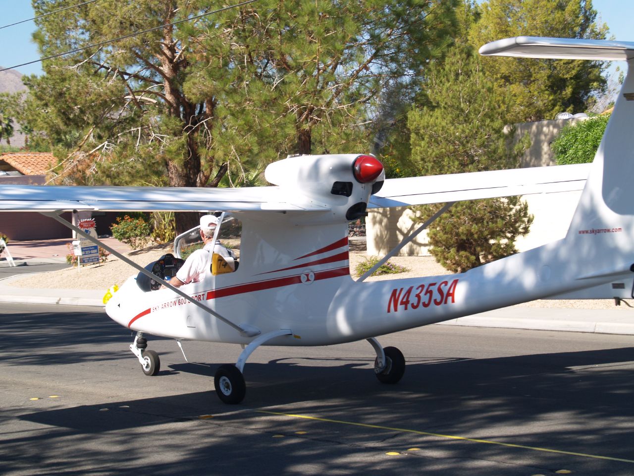 a small plane is parked on the side of the road