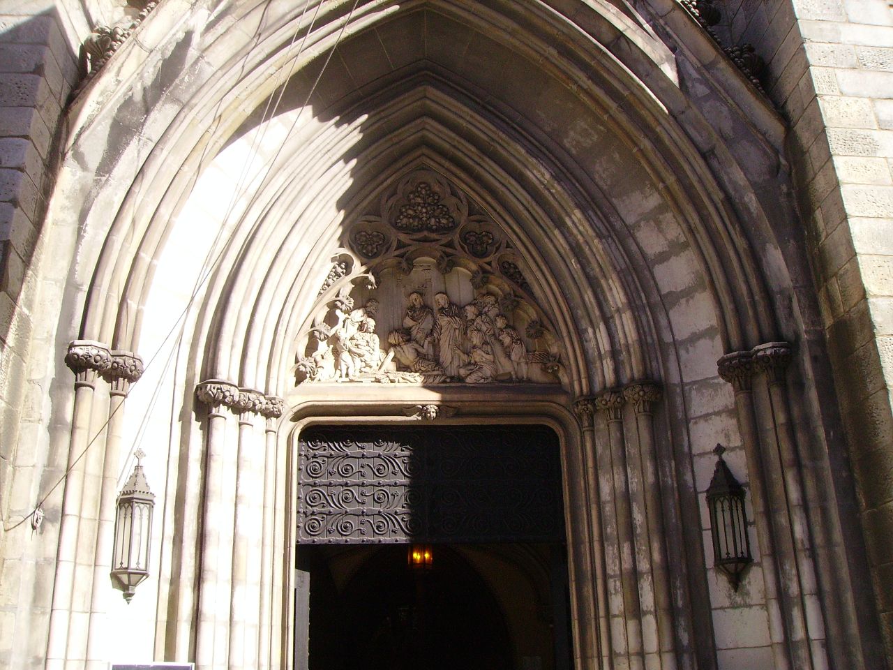 an ornate doorway and a sign at the end