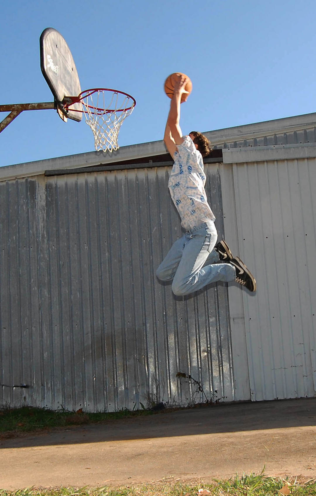 a boy dunking a basketball into the air