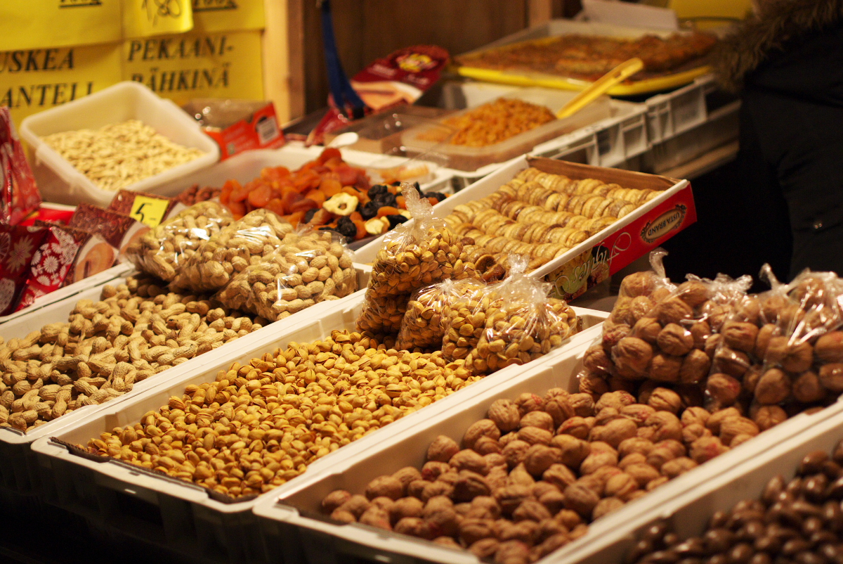 several trays full of nuts in the store