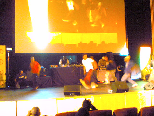 a crowd gathered to watch a presentation in an auditorium