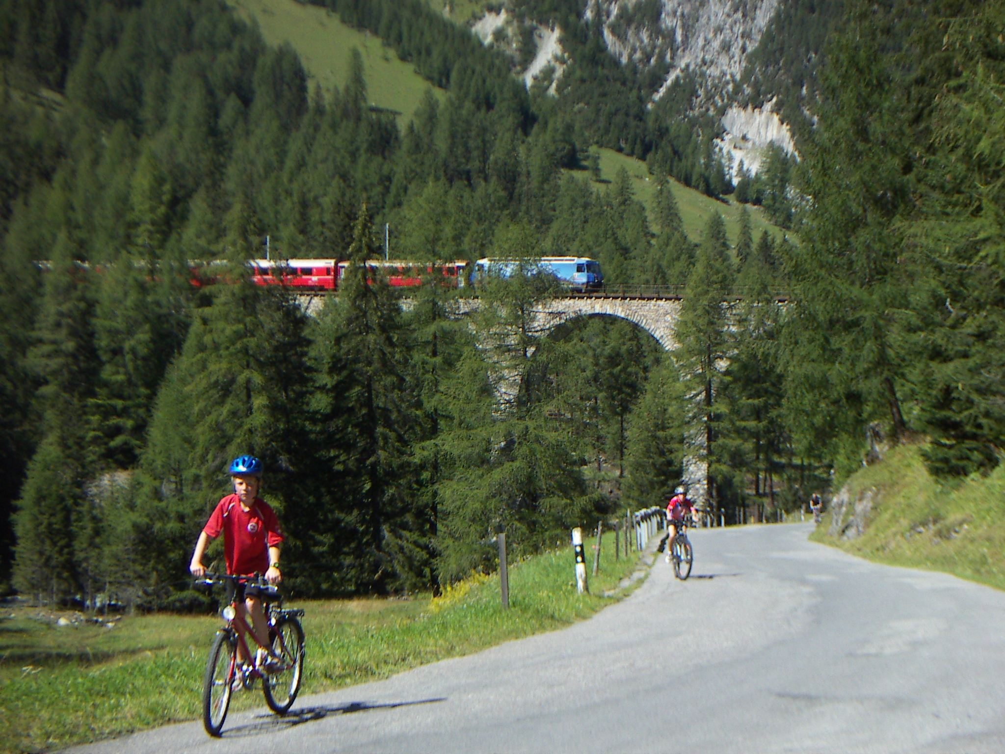 a man riding a bicycle near a woman with bike