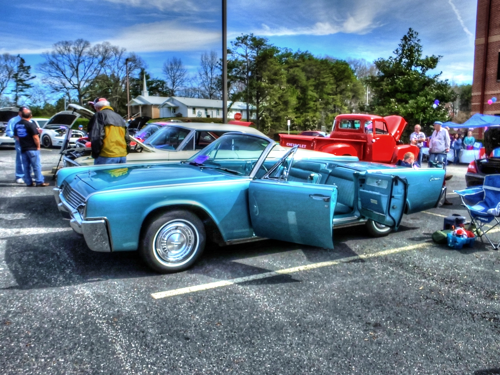 an old fashioned car in a parking lot