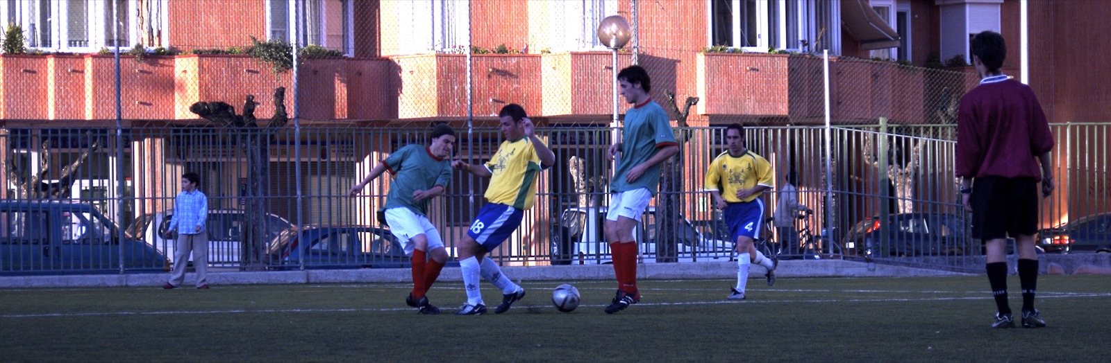 a group of boys playing a game of soccer