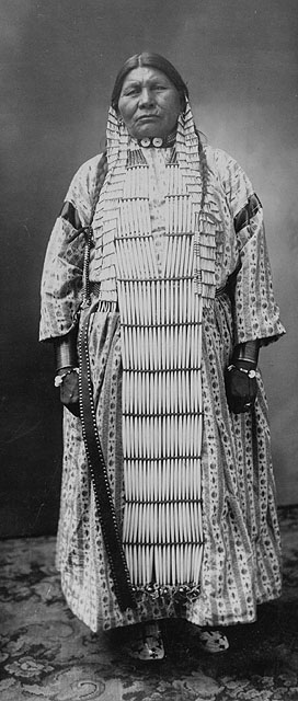 a man dressed in native dress poses for a po