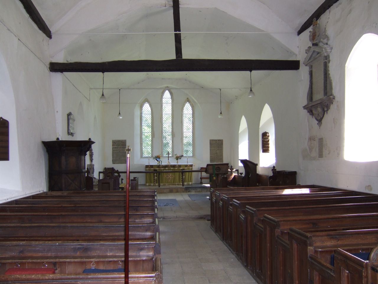 an empty church with pews and windows