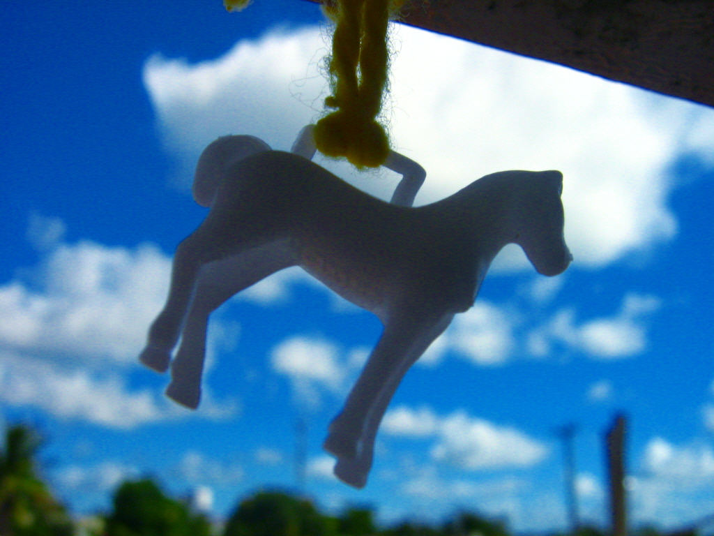a toy horse hanging from a rope