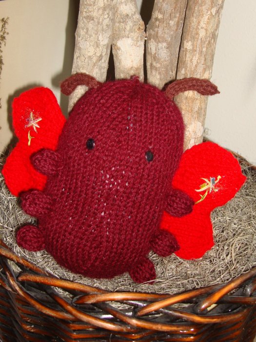 this is an odd looking red knitted animal