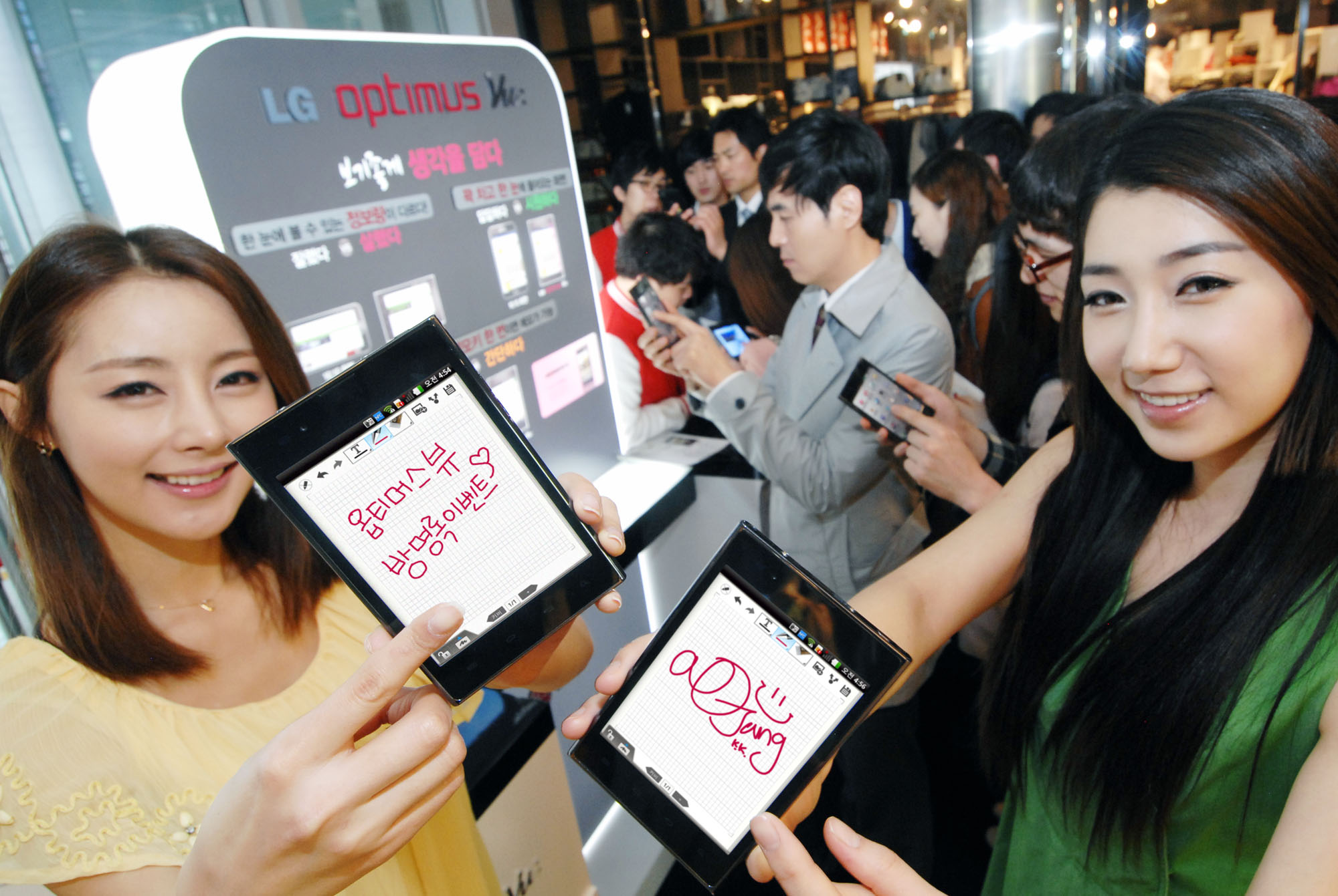 two asian women displaying their kindle electronic devices