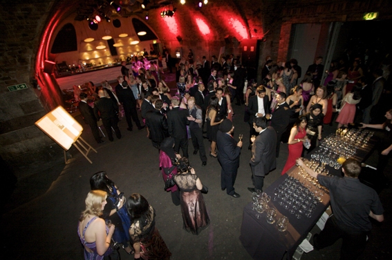 a group of people standing around in a large room