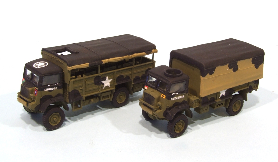 a couple of small green toy army trucks