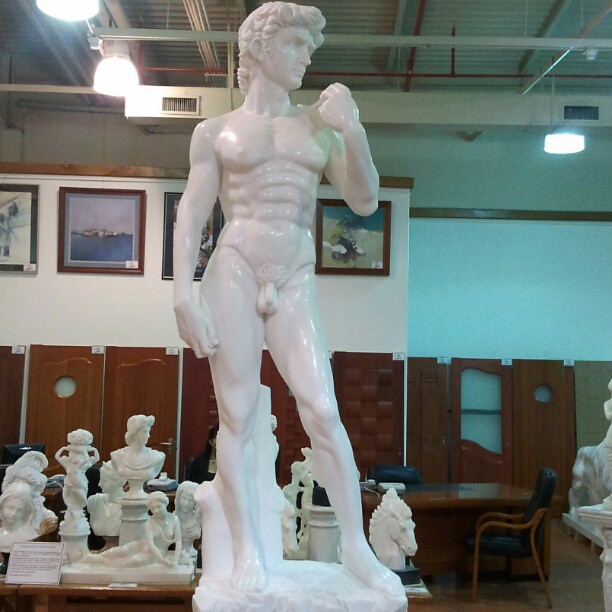 a sculpture of a man with  on in a building