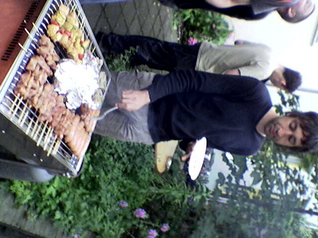 a man grilling on top of an outdoor grill