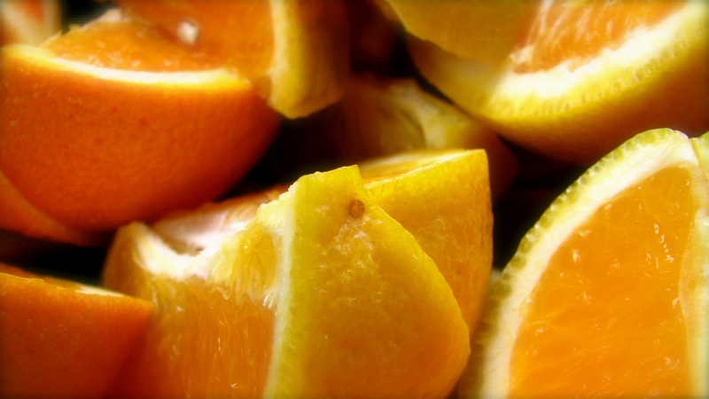 a pograph of a fruit with sliced up oranges