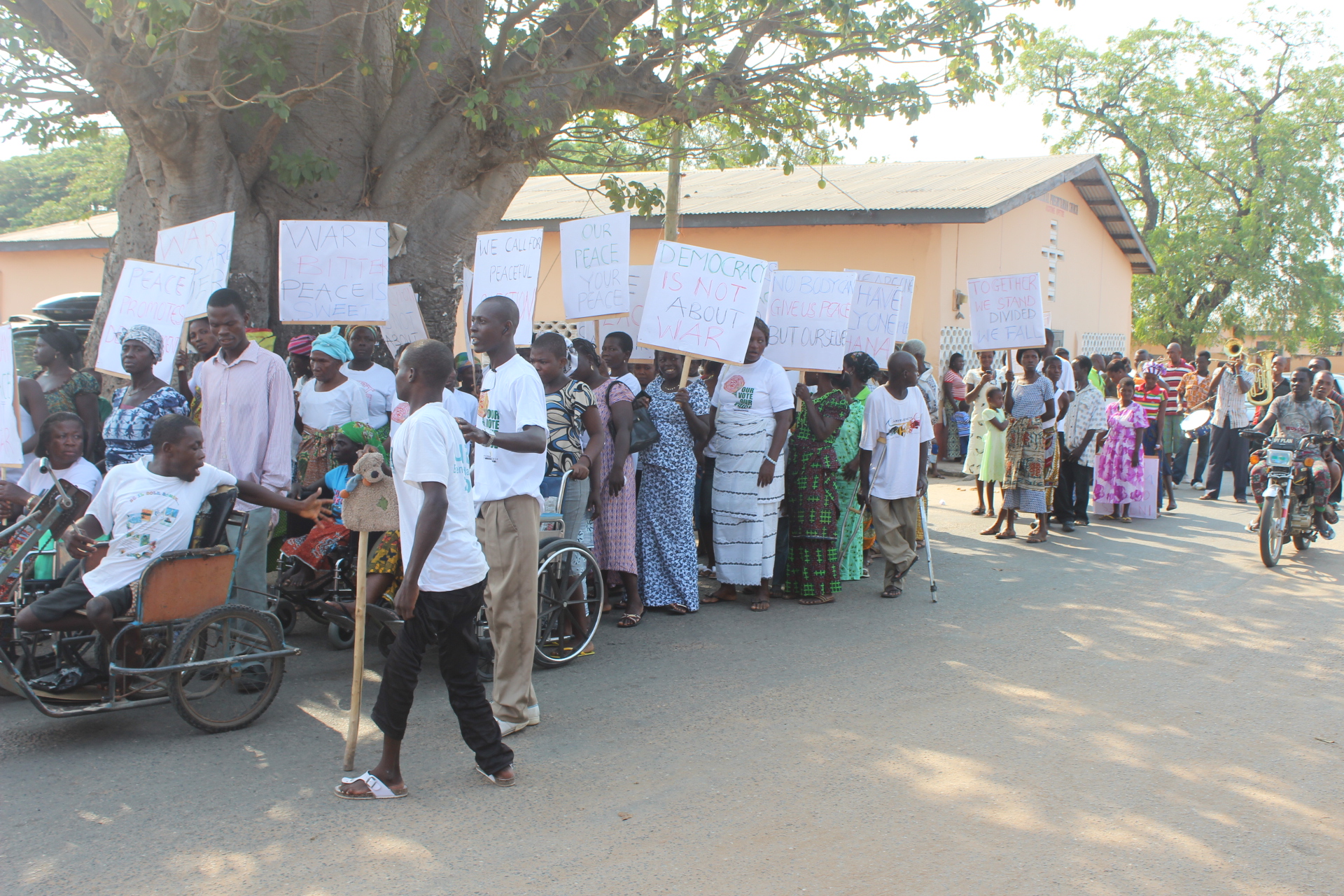 a group of people holding placards in front of a building