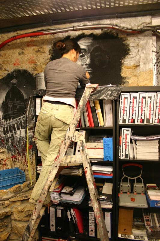 a person climbing on a ladder with books in a bookstore