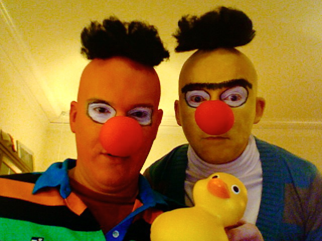 a man poses with a clown and a rubber duck