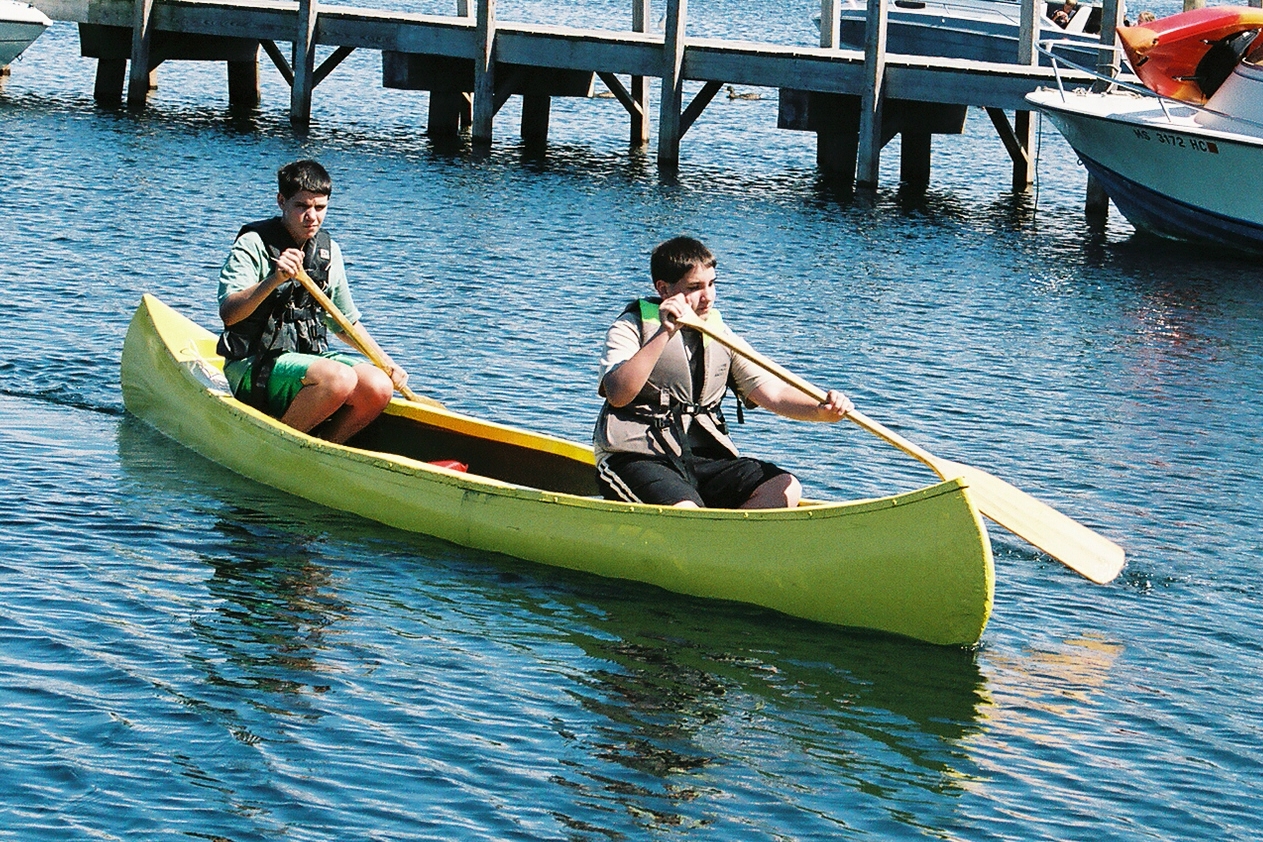 two people are on a canoe in the water