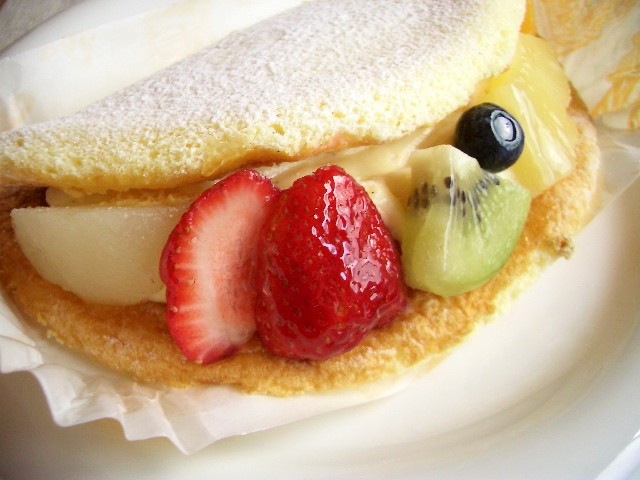 a close up of a dessert on a plate with fruit