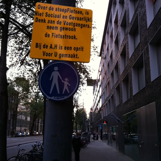 a street sign in german is posted on a pole