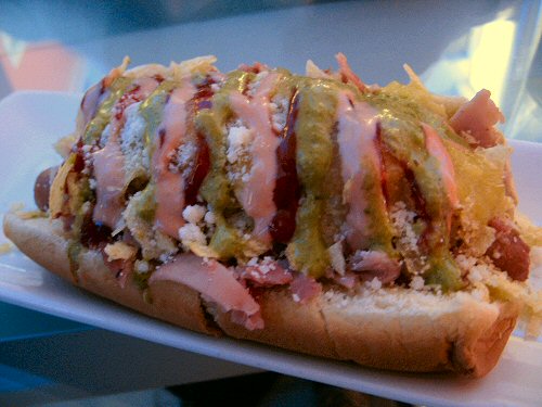 a close up of a  dog covered in toppings