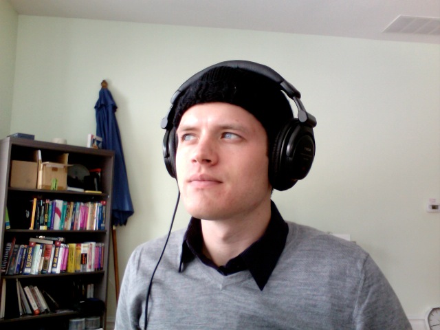 a man wearing headphones and standing in a room