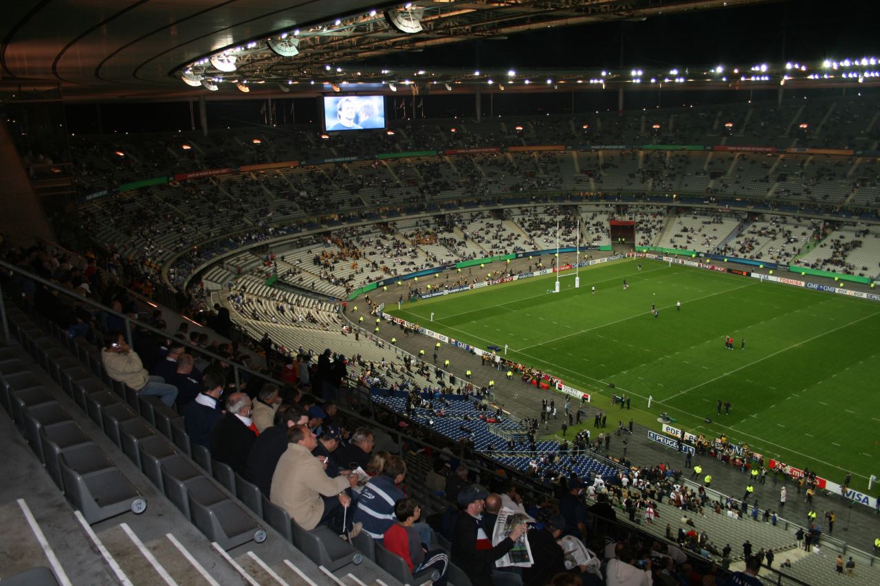 a crowd of people at a stadium watching a soccer game