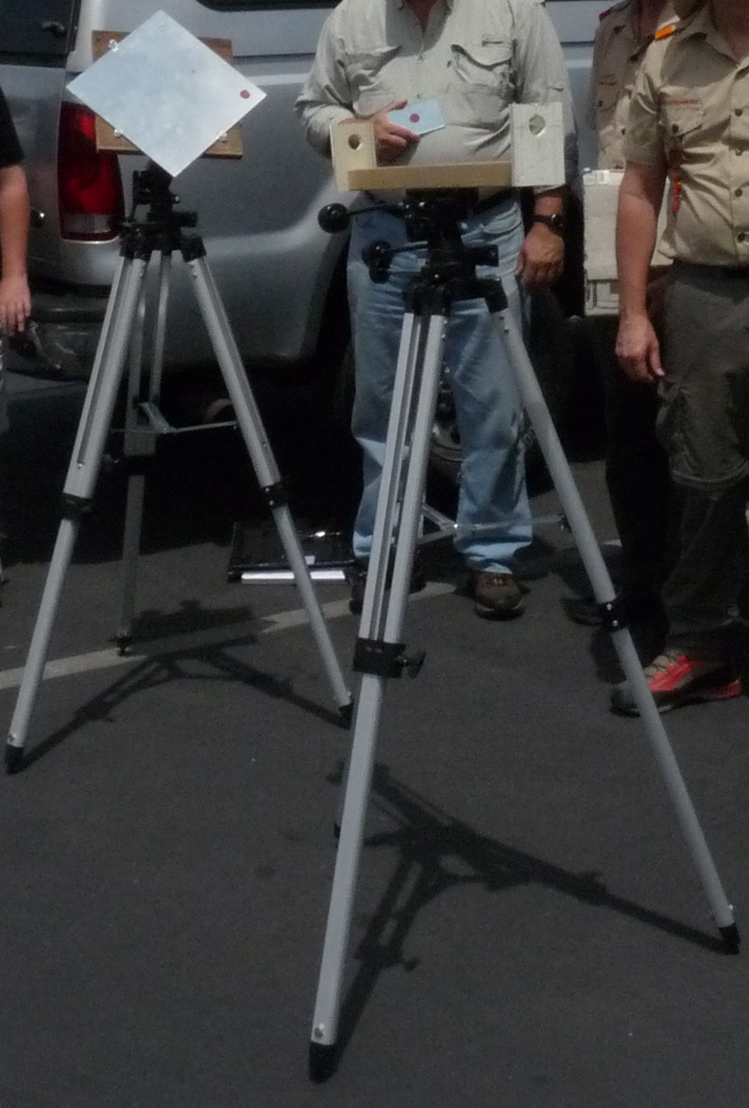 the man is standing near a camera and tripod